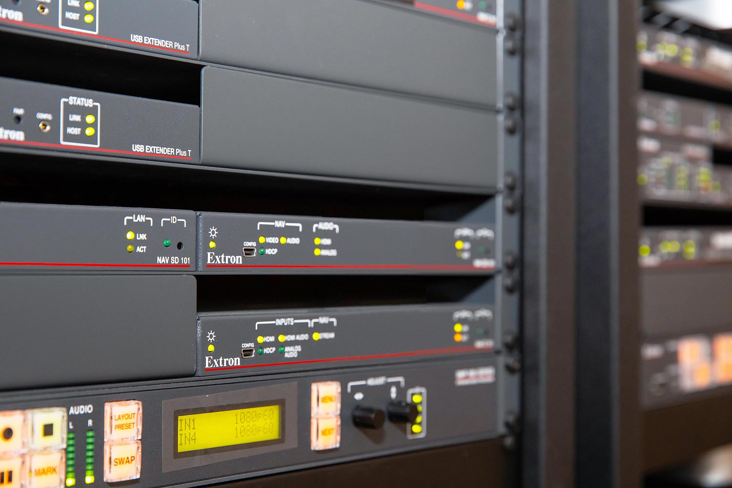 Rack closeup showing NAV AV over IP encoders and decoders and SMP 352 Streaming Media Processor.