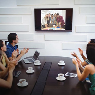 A group of students video conferencing with another team of students.