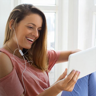 A woman watching a livestream on her tablet..